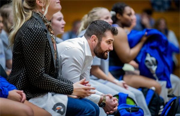 Head coach Jake Short watches one of his wrestlers compete against an opponent from Northern Michigan. 